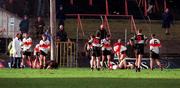 12 December 1999. Two UCC players lie on the ground after an altercation which resulted in Doonbeg player Gerry Killeen being sent off during the AIB Munster Senior Club Football Championship Final match between UCC and Doonbeg at the Gaelic Grounds in Limerick. Photo by Brendan Moran/Sportsfile
