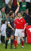 21 April 2007; Liam Fleming, Cliftonville, is shown a yellow card from referee Adrian McCourt. Carnegie Premier League, Cliftonville v Glentoran, Solitude, Belfast, Co. Antrim. Picture credit; Russell Pritchard / SPORTSFILE