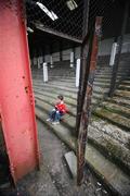 21 April 2007; Cliftonville supporter, eight year old Ronan Begley, sits in &quot;The Cage&quot; which is due to be demolished. Carnegie Premier League, Cliftonville v Glentoran, Solitude, Belfast, Co. Antrim. Picture credit; Russell Pritchard / SPORTSFILE