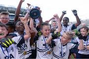 23 October 2014; Fionn Murray, St. Martin De Porres, Aylesbury, lifts the cup alongside his team-mates after winning the Corn Matt Griffin final. Allianz Cumann na mBunscol Finals, Croke Park, Dublin. Picture credit: Pat Murphy / SPORTSFILE