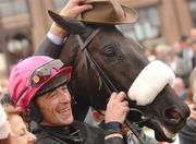 24 April 2007; The hat of trainer Arthur Moore sits above winning horse Mansony's head as winning jockey Davy Russell looks on after winning the Kerrygold Champion Steeplechase. Punchestown National Hunt Festival, Punchestown Racecourse, Co. Kildare. Photo by Sportsfile
