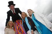 25 April 2007; Stilt walker Garry Rossiter with race fans, from left, Jana Stevenson, from Monkstown, Ciara Corby, from Cork, and Sara Stevenson, from Monkstown, at the Punchestown National Hunt Festival. Punchestown Racecourse, Co. Kildare. Picture credit: Brian Lawless / SPORTSFILE