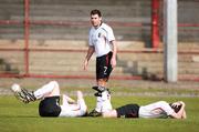 28 April 2007; Glentoran's Dean Fitzgerald looks on as team-mates, Michael Ward and Jamie Reed, lie injured after their heads collided. Carnegie Premier League, Portadown v Glentoran, Shamrock Park, Portadown, Co. Armagh. Picture credit; Russell Pritchard / SPORTSFILE