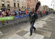 27 October 2014; Jerry Kiernan, himself a winner of the race in 1992, walks along Fitzwilliam Place as participants make their way up at the start of the SSE Airtricity Dublin Marathon 2014. Fitzwilliam Place, Dublin. Picture credit: Ray McManus / SPORTSFILE