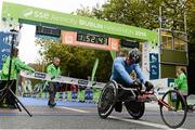 27 October 2014; Patrick Monahan, Naas, Co. Kildare, crosses the finish line to win the Wheelchair race at the SSE Airtricity Dublin Marathon 2014. Merrion Square, Dublin. Picture credit: Pat Murphy / SPORTSFILE