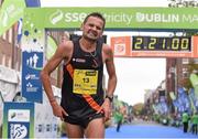 27 October 2014; Sergiu Ciobanu, Clonliffe Harriers A.C., originally from Moldova, now living in Co. Tipperary, crosses the finish line as the first Irish finisher in the men's race at the SSE Airtricity Dublin Marathon 2014. Merrion Square, Dublin. Picture credit: Pat Murphy / SPORTSFILE