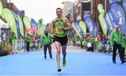 27 October 2014; Barry Minnock, Rathfarnham AC, crosses the finish line as the second Irish finisher in the men's race at the SSE Airtricity Dublin Marathon 2014. Merrion Square, Dublin. Picture credit: Pat Murphy / SPORTSFILE