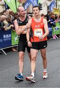 27 October 2014; Gerard McNamara, left, helps Joe Dunny the last 100 yards to the finish of the SSE Airtricity Dublin Marathon 2014. Merrion Square, Dublin. Picture credit: Ray McManus / SPORTSFILE