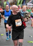 27 October 2014; Cathal O' Donnell, Republic of Ireland, with his daughter Beth, 18 months old, after finishing the SSE Airtricity Dublin Marathon 2014. Merrion Square, Dublin. Picture credit: Ray McManus / SPORTSFILE