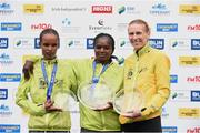 27 October 2014; Esther Wanjiru Macharia, Kenya, winner of the women's race at the SSE Airtricity Dublin Marathon 2014 with second placed Maria McCambridge, Dundrum South Dublin AC, right, and third placed Meseret Godana, Ethiopia, left. Merrion Square, Dublin. Picture credit: Pat Murphy / SPORTSFILE