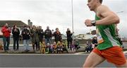 27 October 2014; A participant is cheered on by spectators as he makes his way down Cromwellsfort Road West during the SSE Airtricity Dublin Marathon 2014.  Picture credit: Barry Cregg / SPORTSFILE
