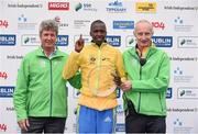 27 October 2014; Eliud Too, Kenya, celebrates after winning the men's race at the SSE Airtricity Dublin Marathon 2014 alongside Mark Ennis, Chairman SSE Ireland, left, and Jim Aughney, SSE Aitricity Dublin Marathon Race Director, right. Merrion Square, Dublin. Picture credit: Pat Murphy / SPORTSFILE