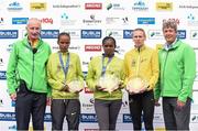 27 October 2014; Esther Wanjiru Macharia, Kenya, winner of the women's race at the SSE Airtricity Dublin Marathon 2014 with second placed Maria McCambridge, Dundrum South Dublin AC, right, third placed Meseret Godana, Ethiopia, left, Jim Aughney, SSE Aitricity Dublin Marathon Race Director, left, and Mark Ennis, Chairman SSE Ireland, right. Merrion Square, Dublin. Picture credit: Pat Murphy / SPORTSFILE
