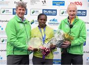 27 October 2014; Esther Wanjiru Macharia, Kenya, winner of the women's race at the SSE Airtricity Dublin Marathon 2014 with Mark Ennis, Chairman SSE Ireland, left, and Jim Aughney, SSE Aitricity Dublin Marathon Race Director. Merrion Square, Dublin. Picture credit: Pat Murphy / SPORTSFILE