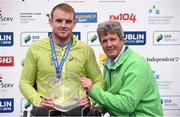 27 October 2014; Winner of the Wheelchair race at the SSE Airtricity Dublin Marathon 2014 Patrick Monahan, Naas, Co. Kildare, is presented with his prize by Mark Ennis, Chairman SSE Ireland, right. Merrion Square, Dublin. Picture credit: Pat Murphy / SPORTSFILE