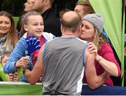 27 October 2014; Deirdre Cotter, from Portarlington, Co. Laois, embraces her husband, Kieran, St. Michael's AC, 100 yards from the finish of the SSE Airtricity Dublin Marathon 2014. Merrion Square, Dublin. Picture credit: Ray McManus / SPORTSFILE
