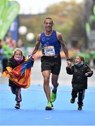 27 October 2014; Eduard Aixala, from Catalonia, Spain, crosses the finish line with his children, 6 year old Laia, left, and 4 year old Arnau, during the SSE Airtricity Dublin Marathon 2014 at Merrion Square in Dublin. Photo by Ramsey Cardy/Sportsfile