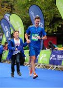 27 October 2014; Thomas Pender, from Artane, Co. Dublin, approaches the line with his son Calum, age eight, during the SSE Airtricity Dublin Marathon 2014. Merrion Square, Dublin. Picture credit: Tomas Greally / SPORTSFILE