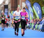 27 October 2014; Roisin Daly and Kerrie Lynch, both from Killarney, Co. Kerry, approach the finish line during the SSE Airtricity Dublin Marathon 2014. Merrion Square. Dublin. Picture credit: Tomas Greally / SPORTSFILE