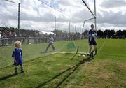 7 May 2007; Four-year-old Oscar Corrigan, who played in goal during half-time, eyes up Dublin goalkeeper John Leonard as he take his place for the second half. Senior Football Challange, Dublin v Galway, Garda GAA Club, Westmeanstown Sports Complex, Lucan, Co. Dublin. Picture credit: Ray McManus / SPORTSFILE