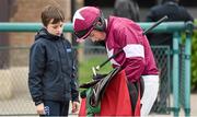 29 October 2014; Jockey Brian Cooper signs his autograph for Eoin Lane aged 12, from Eadstown, Co.Kildare, during the days races. Punchestown Racecourse, Punchestown, Co. Kildare. Picture credit: Barry Cregg / SPORTSFILE