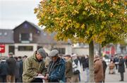 29 October 2014; A general view of racegoers marking their card during the days races. Punchestown Racecourse, Punchestown, Co. Kildare. Picture credit: Barry Cregg / SPORTSFILE
