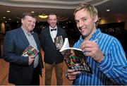 29 October 2014; Conor Mortimer signs his book with John O'Mahony, TD and former All-Ireland winning player and manager and Jackie Cahill during the launch of the book 'One Sunday: A Day in the Life of the Mayo Football Team' by Conor Mortimer with Jackie Cahill (published by Hero Books, priced €16.99). McWilliam Hotel, Claremorris, Co. Mayo. Picture credit: Ray Ryan / SPORTSFILE