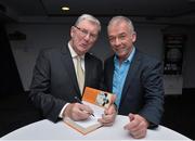 30 October 2014; Eugene McGee autographs his book for Chairman of the National Referee Committee Pat McEnaney at the launch of his book 'The GAA in My Time' by Eugene McGee. Croke Park, Dublin. Picture credit: Matt Browne / SPORTSFILE