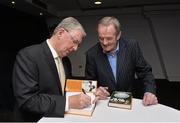 30 October 2014; Eugene McGee autographs his book for former Dublin great Jimmy Keaveney at the launch of his book 'The GAA in My Time' by Eugene McGee. Croke Park, Dublin. Picture credit: Matt Browne / SPORTSFILE