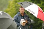 18 May 2007; Brendan Cronin and his son Brendan Jnr, from Killarney, Co. Kerry, take cover from the wind and rain during the 2nd Round. Irish Open Golf Championship, Adare Manor Hotel and Golf Resort, Adare, Co. Limerick. Picture credit: Matt Browne / SPORTSFILE