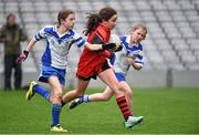 3 November 2014; Niamh Byrne, Holy Trinity NS, Donaghmede, in action against Roisin Ni Chathasaigh, left, and Sadhbh Ni Dhraighneain, right, Gaelscoil Thaobh na Coille, Stepaside, during the Sciath an Chladaigh final. Allianz Cumann na mBunscol Finals, Croke Park, Dublin. Picture credit: Pat Murphy / SPORTSFILE