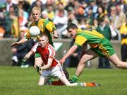 27 May 2007; Gary McCoey, Armagh, in action against Michael Murphy and Patrick McGowan, Donegal. ESB Ulster Minor Football Championship, Donegal v Armagh, MacCumhaill Park, Ballybofey, Co. Donegal. Picture credit: Oliver McVeigh / SPORTSFILE