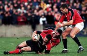 8 January 2000; Darragh O'Mahoney of Saracens is tackled by Munsters John Kelly and Dominic Crotty, right, during the Heineken Cup Pool 4 Round 5 match between Munster and Saracens at Thomond Park in Limerick. Photo by Ray Lohan/Sportsfile
