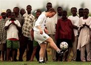 30 March 1999; Gerard Crossley is watched by locals during a Republic of Ireland training session in Ibadan, Nigeria, at the 1999 FIFA World Youth Championship Finals. Photo by David Maher/Sportsfile