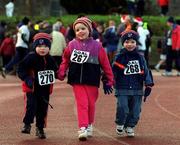 25 December 1999; Ashling Fitzpatrick, age 5, with her brothers John, age 2, and James, age 3, from Dalkey, at Belfield Running Track in Dublin, during one of the many 'Goal Miles' on Christmas Day. Photo by Ray McManus/Sportsfile