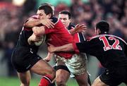 8 January 2000; Munster's Jason Holland is tackled by theirry Lacroix and Kevin Sorrell of Saracens during the Heineken Cup Pool 4 Round 5 match between Munster and Saracens at Thomond Park in Limerick. Photo by Brendan Moran/Sportsfile