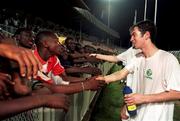 30 March 1999; Keith Doyle greets locals following a Republic of Ireland training session at Liberty Stadium in Ibadan, Nigeria. Photo by David Maher/Sportsfile