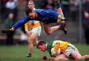 23 January 2000; John Greene of Offaly in action against Longford's Paul Ross during the O'Byrne Cup Semi-Final match between Longford and Offaly at Pearse Park in Longford. Photo by Ray McManus/Sportsfile