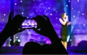 8 November 2014; A member of the audience records a video on their smartphone of singer Melanie McCabe performing during the TG4 Ladies Football All-Star Award. TG4 Ladies Football All-Star Awards 2014, Citywest Hotel, Saggart, Co. Dublin. Picture credit: Brendan Moran / SPORTSFILE