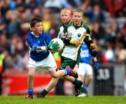 3 June 2007; &quot;Gearing Up for Cúl Camps&quot;. Pictured playing for the Vhi Cúl Camps Team in Croke Park on Sunday are James Healy, St. Conleth's & Mary's, Newbridge, representing Kildare, is tackled by Colin Green, Bishop Galvin National School, representing Dublin. Bank of Ireland Leinster Senior Football Championship, Meath v Dublin, Croke Park, Dublin. Picture Credit: Ray McManus / SPORTSFILE