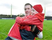 9 November 2014; Cillian O'Connor, Balllintubber, celebrates with Owen Breslin, age 9, from Ballintubber at the end of the game. AIB Connacht GAA Football Senior Club Championship, Semi-Final, Ballintubber v St Brigid's, Elverys MacHale Park, Castlebar, Co. Mayo. Picture credit: David Maher / SPORTSFILE