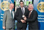 8 November 2014; Referee Gary McCormack, from Dublin, is presented with his Junior Football 2013 referees' medal by Pat McEnaney, Chairman of National Referee Committee, left, and Frank Burke, Vice-President of the GAA. 2014 National Referees' Awards Banquet, Croke Park, Dublin. Picture credit: Barry Cregg / SPORTSFILE