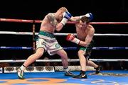 15 November 2014; Kofi Yates, left, exchanges punches with Oisin Fagan during their light-welterweight bout. Return of The Mack, 3Arena, Dublin. Picture credit: Ramsey Cardy / SPORTSFILE