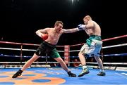 15 November 2014; Kofi Yates, right, exchanges punches with Oisin Fagan during their light-welterweight bout. Return of The Mack, 3Arena, Dublin. Picture credit: Ramsey Cardy / SPORTSFILE
