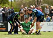 16 November 2014; Eamonn O'Muirchearthaigh, the Ireland chartered physiotherapist and Dr Kevin Moran attend to Colm O'Neill. VFL Selection v Ireland - International Rules warm-up match, Sandringham VFL Ground, Trevor Barker Beach Oval, Melbourne, Victoria, Australia. Picture credit: Ray McManus / SPORTSFILE