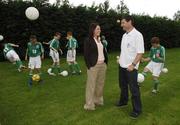 25 June 2006; Former Republic of Ireland star and 'Godfather' to this year's Irish team, Denis Irwin, met once again with the talented young Cherry Orchard team who will travel to Lyon to represent Ireland in less than a week's time at the Danone Nations Cup World Final. Irwin took the young team under his wing one last time to pass on his expertise and vast knowledge of International soccer. Pictured is Denis in conversation with Deirdre O'Leary, Brand Manager Danone. AUL Complex, Clonshaugh, Dublin. Picture credit: Brendan Moran / SPORTSFILE