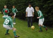 25 June 2006; Former Republic of Ireland star and 'Godfather' to this year's Irish team, Denis Irwin, met once again with the talented young Cherry Orchard team who will travel to Lyon to represent Ireland in less than a week's time at the Danone Nations Cup World Final. Irwin took the young team under his wing one last time to pass on his expertise and vast knowledge of International soccer. Pictured is Denis showing some skills to team members Stephen Coghlan, right, and Kevin Nolan. AUL Complex, Clonshaugh, Dublin. Picture credit: Brendan Moran / SPORTSFILE