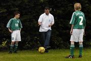 25 June 2006; Former Republic of Ireland star and 'Godfather' to this year's Irish team, Denis Irwin, met once again with the talented young Cherry Orchard team who will travel to Lyon to represent Ireland in less than a week's time at the Danone Nations Cup World Final. Irwin took the young team under his wing one last time to pass on his expertise and vast knowledge of International soccer. Pictured is Denis showing some tips to team members Kevin Nolan, left, and Stephen Coghlan. AUL Complex, Clonshaugh, Dublin. Picture credit: Brendan Moran / SPORTSFILE