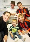 27 June 2007; eircom League of Ireland players, from left, Tadhg Purcell, Shamrock Rovers, Barry Ferguson, Shamrock Rovers, Jason McGuinness, Bohemians, and John Paul Kelly, Bohemians, with Ben O'Brien, age 4, from Enniscorthy, Wexford, on a visit to Temple Street Children's University Hospital, in advance of their eircom League of Ireland fixture in Tolka Park this coming friday. Temple Street, Dublin. Picture credit: Brian Lawless / SPORTSFILE