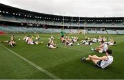 21 November 2014; Members of the Ireland squad listen to high performance coach Nicholas Walsh as they warm up aheaad of squad training before their International Rules Series game against Australia on Saturday. Ireland International Rules Squad Training, Paterson's Stadium, Perth, Australia. Picture credit: Ray McManus / SPORTSFILE